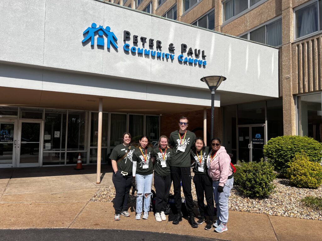 Students pose for a photo outside of Peter & Paul Community Center